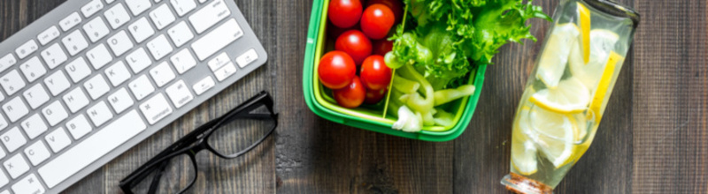 Eat at workplace. Lunch box with vegetable sandwiches near computer on dark wooden background top view copyspace Eat at workplace. Lunch box with vegetable sandwiches near computer on dark wooden background top view copyspace