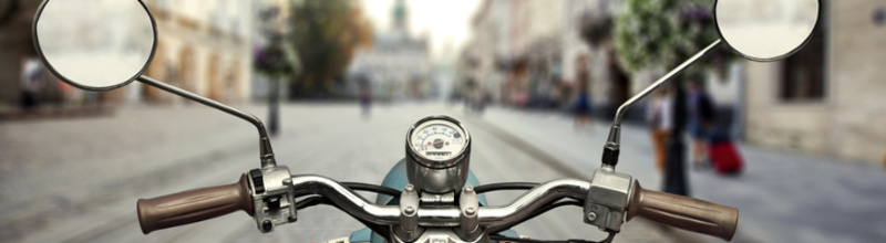 Scooter on foregrounf and blurred view on city on background Scooter on foregrounf and blurred view on city on background
